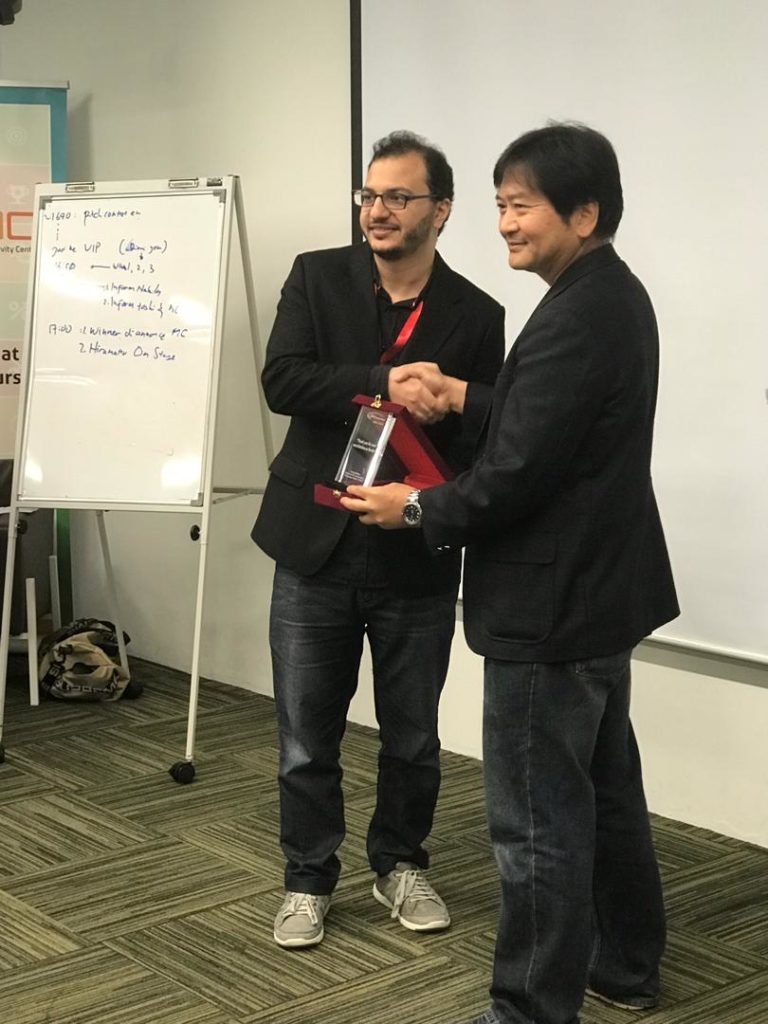 Homam Alghorani founder of Wonderland Technologies Sdn Bhd receiving the finalist NTT startup challenge award